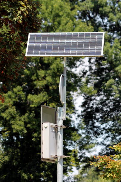 istock LED traffic sign mounted on strong metal pole and powered with small solar panel on top in local public park 1202273640