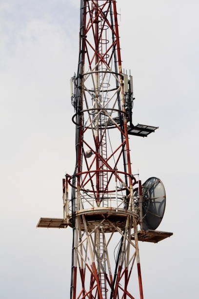 istock Middle part of strong tall cell phone red and white antenna tower with multiple antennas and transmitters 1202273674
