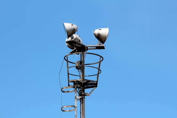 istock High metal platform with three large industrial electrical reflector lights surrounded with protective fence 1202273895