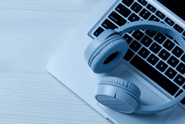 istock Headphones and laptop on table 1202274080