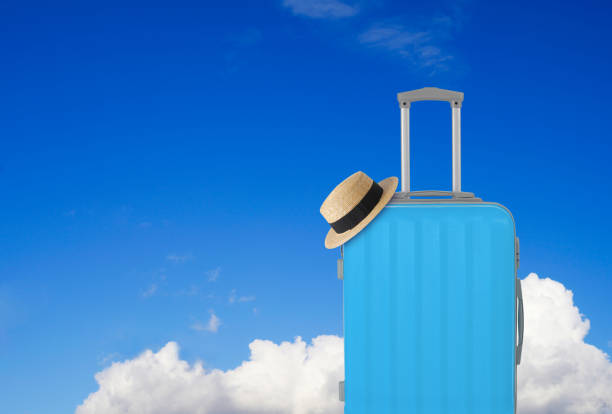 istock Blue luggage and straw hat 1202274124