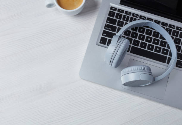 Headphones, laptop and coffee stock photo
