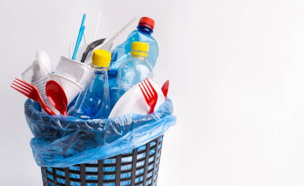 istock A black trash can with used plastic items isolated on white 1202274760