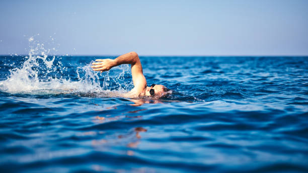 Swimmer training on the open sea / ocean. stock photo