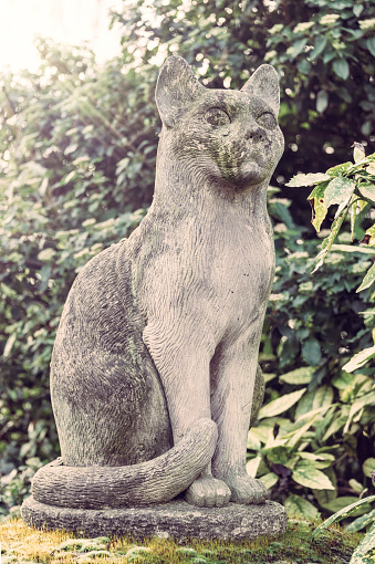 Stone cat statue in the pet cemetery of Paris in Asnières-sur-Seine, France. The \