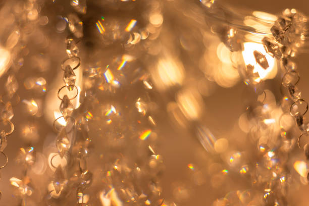 istock Blurred Background Chrystal chandelier lamp on the ceiling in Dining room Adjusting the image in a Luxury tone . Decorative elegant vintage and Contemporary interior Concept. 1202279574