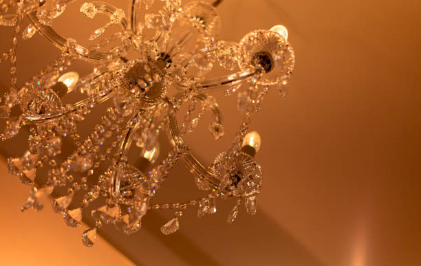 istock Blurred Background Chrystal chandelier lamp on the ceiling in Dining room Adjusting the image in a Luxury tone . Decorative elegant vintage and Contemporary interior Concept. 1202280280