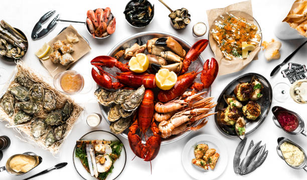 Crayfish and seafood table top view. Lobsters, crayfish, shrimps, clams, oysters, sushi Crayfish and seafood table top view. Lobsters, crayfish, shrimps, clams, oysters, sushi. On a white tablecloth lobster seafood photos stock pictures, royalty-free photos & images