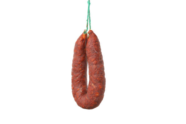 istock Delicious hanging sausage isolated on white background 1202282865