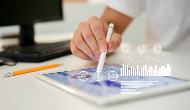 istock close up businessman using pen to planning financial strategy on tablet with dashboard tools monitor for futuristic technology concept 1202283177