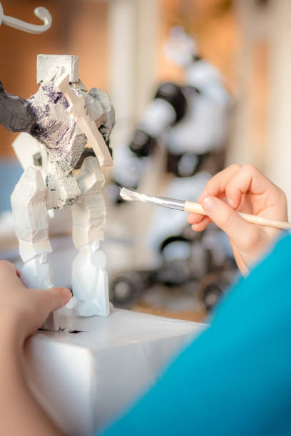 istock Little boy painting a robot skeleton. 1202283403