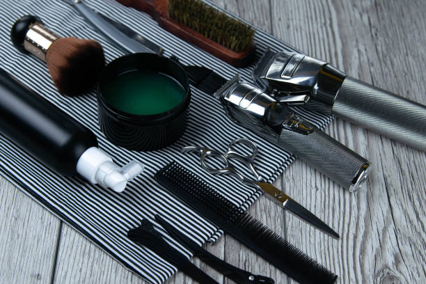 istock Flat lay from hairdressing accessories including: haircuts, scissors, combs, gels for styling and shaving laid 1202283518