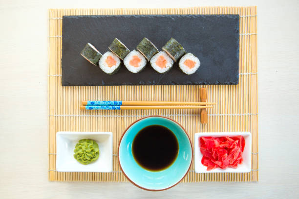 istock salmon sushi rolls on black slate surface. Japanese food 1202283998