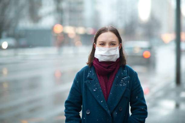 istock Young girl wearing a protective face mask 1202284680