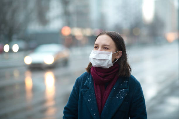 istock Young girl wearing a protective face mask 1202284706