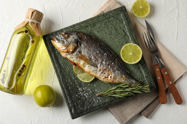 istock Square plate with Dorado on garnished white background, top view 1202288167