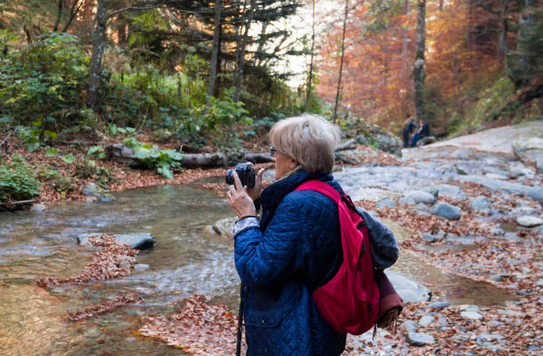 istock Senior woman hikes along the mountain 1202289863