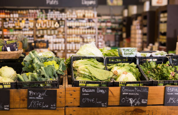 istock Fresh cabbage and broccoli on the counter in the store 1202289891