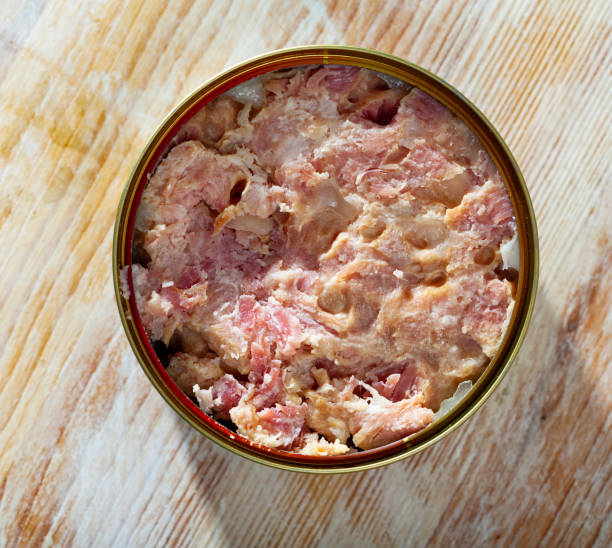 istock Tin can with ham on a wooden surface 1202290310