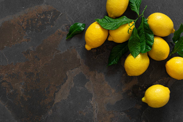 istock Fresh lemons with leaves, vitamin c concept, top view 1202290316