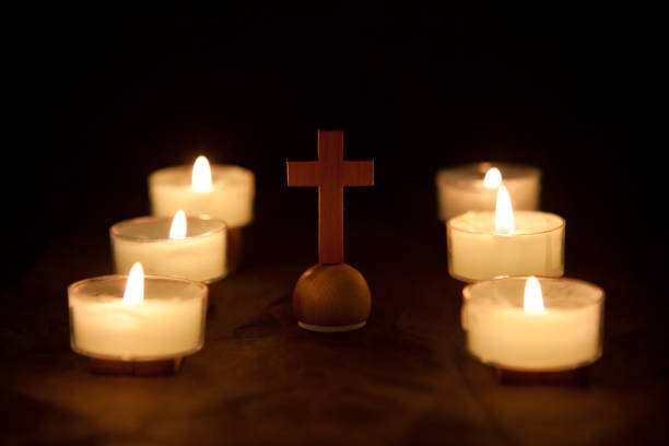 istock cross with candle light Resurrection 1202290608