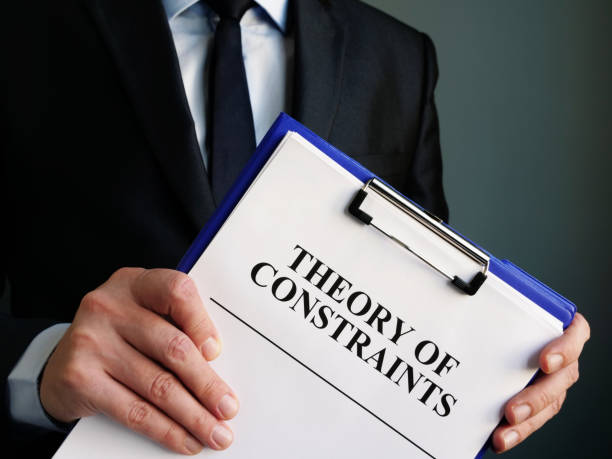 istock Businessman holds toc theory of constraints papers. 1202291784