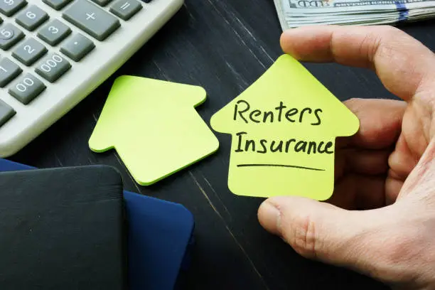 Photo of Renters insurance sign on the house shaped sheet.