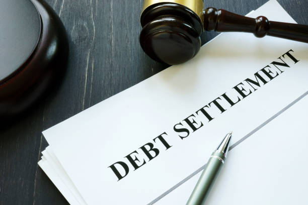 istock Debt Settlement agreement papers with gavel. 1202291960