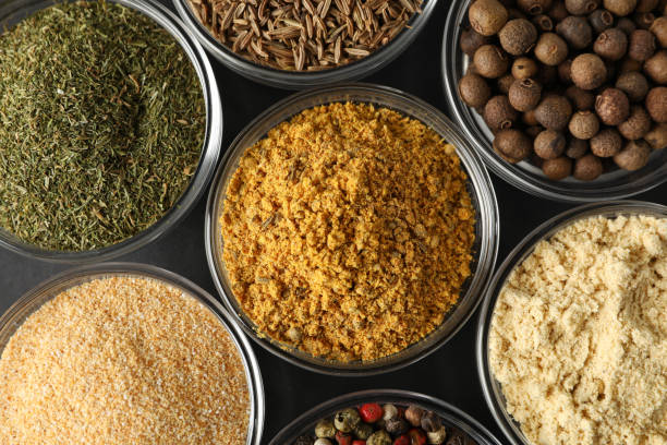 istock Bowls with different spices on black background, top view and close up 1202292014