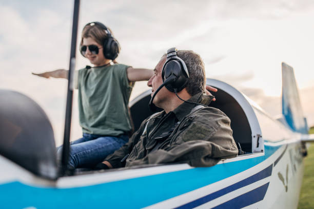 istock Father and daughter in propeller airplane 1202292162