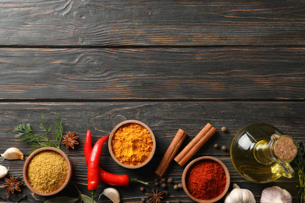 istock Bowls with different spices and ingredients on wooden background, space for text 1202292440