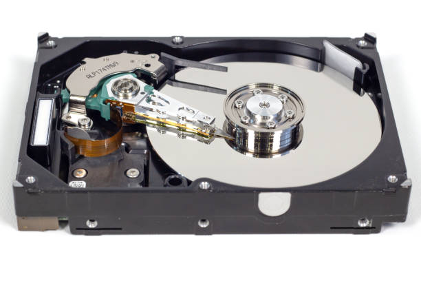 istock Disassemble a hard drive from a computer, a hard drive with a mirror effect a hard drive from a computer, a hard drive with a mirror effect Part of a computer, close-up HDD 1202292655