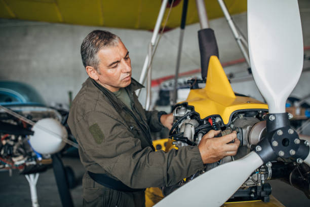 istock One airplane mechanic repairing propeller airplane 1202293532
