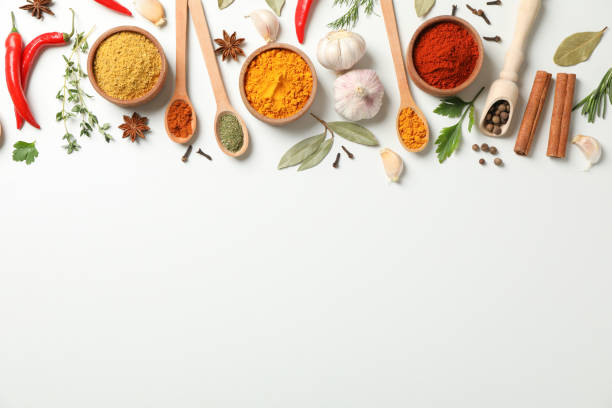 istock Spoons and bowls with different spices and ingredients on white background, space for text 1202293773