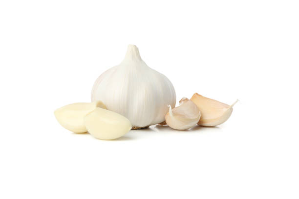 istock Fresh garlic bulb and slices isolated on white background 1202293993