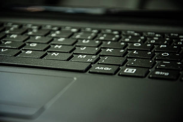 a laptop keyboard in close-up view in selective focus