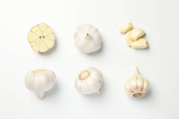 istock Flat lay with garlic bulbs on white background, top view 1202295364