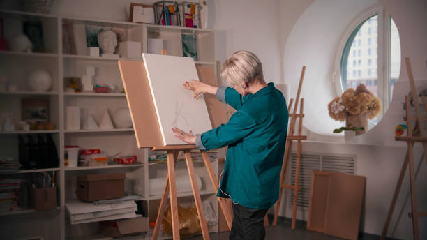 istock A young woman sketching an abstract tree on the canvas 1202296840