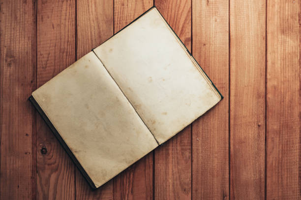 istock Open Vintage book on a red wooden table background. Top view. 1202297789
