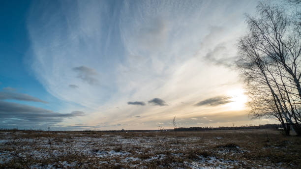 Beautiful setting sun over frozen field stock photo