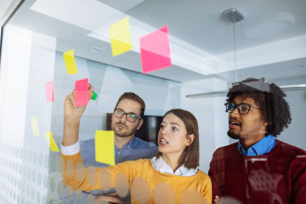 istock Business people brainstorming ideas behind glass wall 1202298569