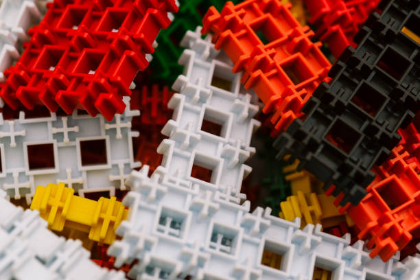 istock Designer cubes of different colors are scattered on the table. Parts for assembling different models of toys. Educational concept, background 1202298790