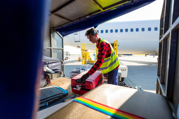 istock Airport service crew unloading luggage 1202301339