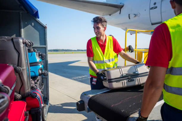 istock Airport service crew unloading luggage 1202301576