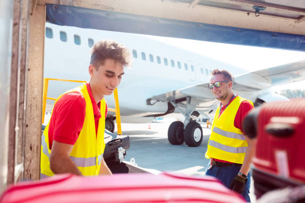 istock Airport service crew unloading luggage 1202301717