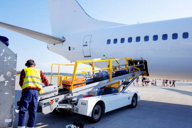 istock Airport service crew unloading luggage 1202301817
