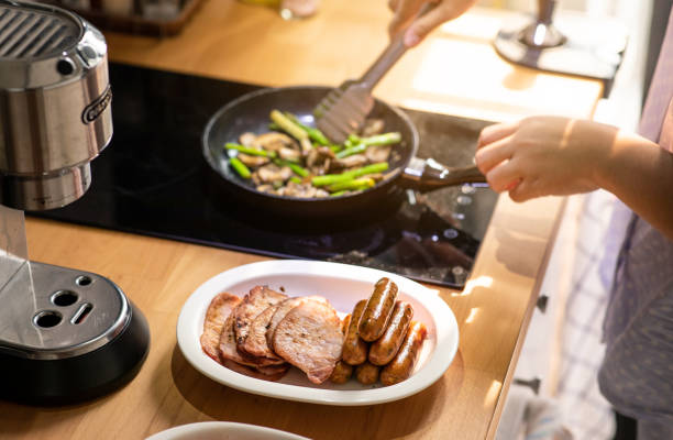 female cooking breakfast on kitchen counter bar.healthy food,simple eating - meat steak over eating women imagens e fotografias de stock