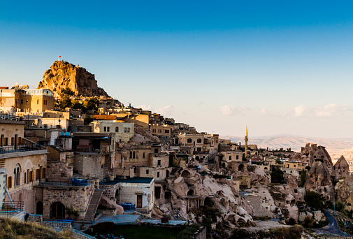 Sunset view of the fortress and the city Uchisar in Cappadocia. Anatolia, Turkey.