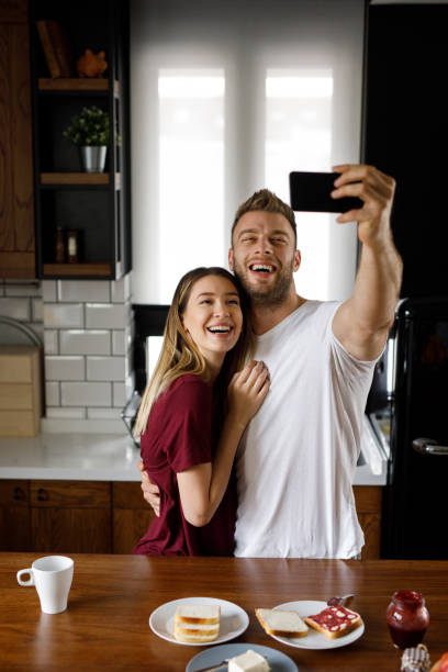 istock Couple taking a Selfie together in the kitchen during breakfast 1202304673