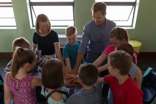 istock Group of elementary school kids sitting in a circle 1202306201